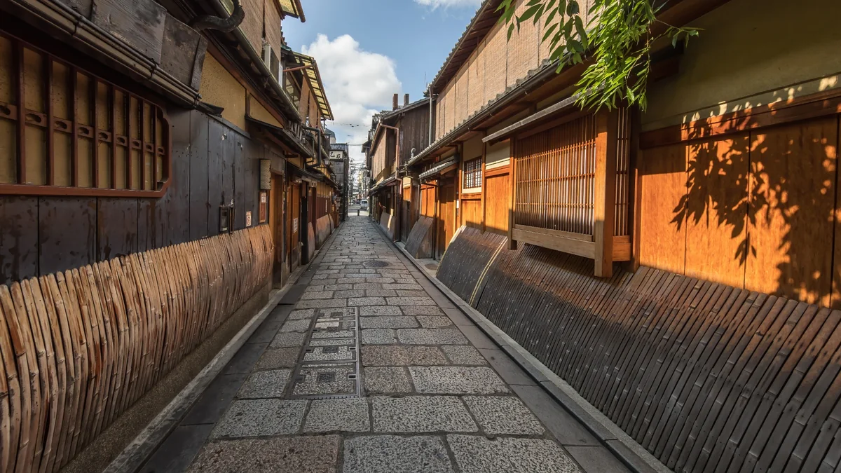 Traditional wooden houses along a stone-paved street in Gion, Kyoto