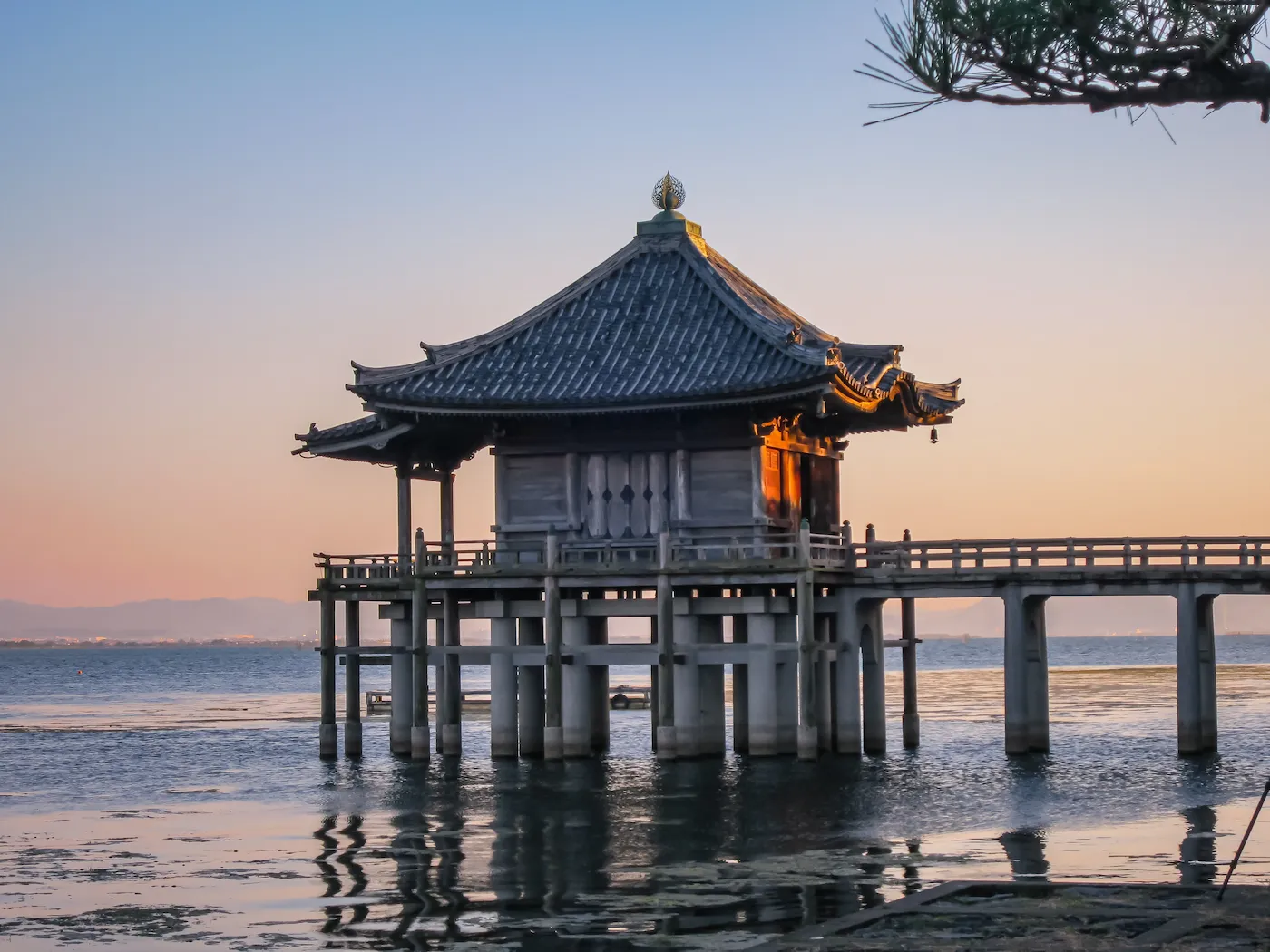 Ukimido pavilion extending over Lake Biwa at sunset in Otsu