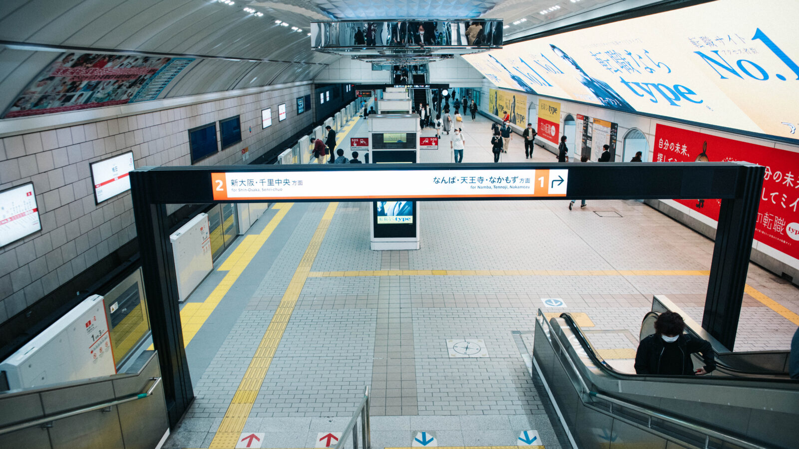 Osaka Metro platform and signs at Umeda Station