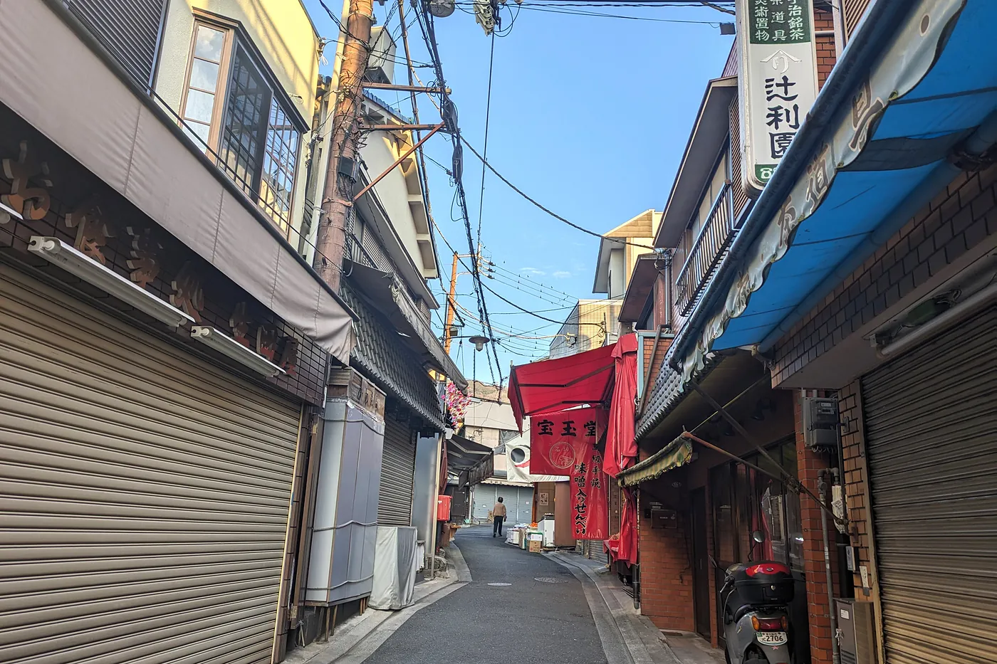 Quiet Ishikiri Sando shopping street in Osaka with traditional storefronts and overhead wires