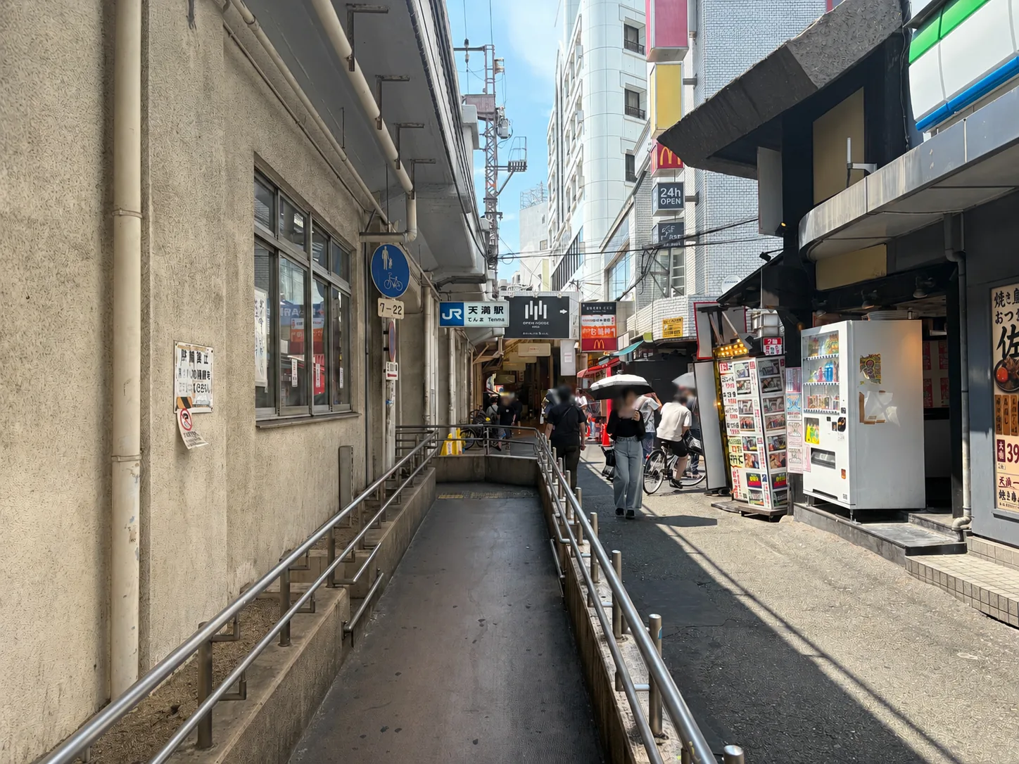 JR Tenma Station entrance surrounded by local restaurants in Osaka