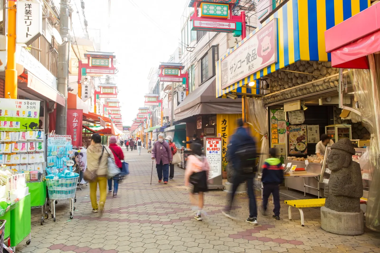 Colorful shops and visitors along the main street of Osaka Korea Town