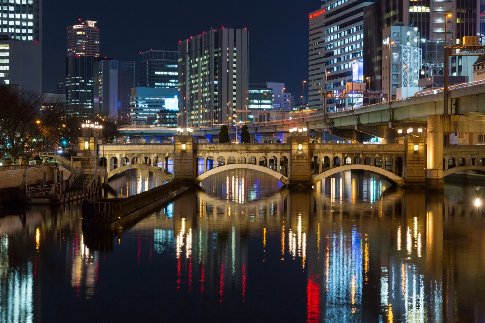 Suishobashi Bridge and river reflections in Nakanoshima, Osaka at night
