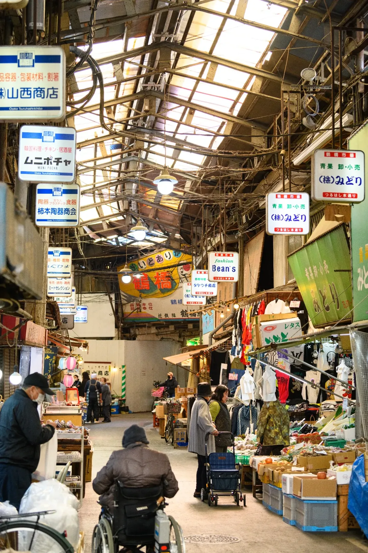 Local shoppers and produce stalls inside Tsuruhashi Market in Osaka