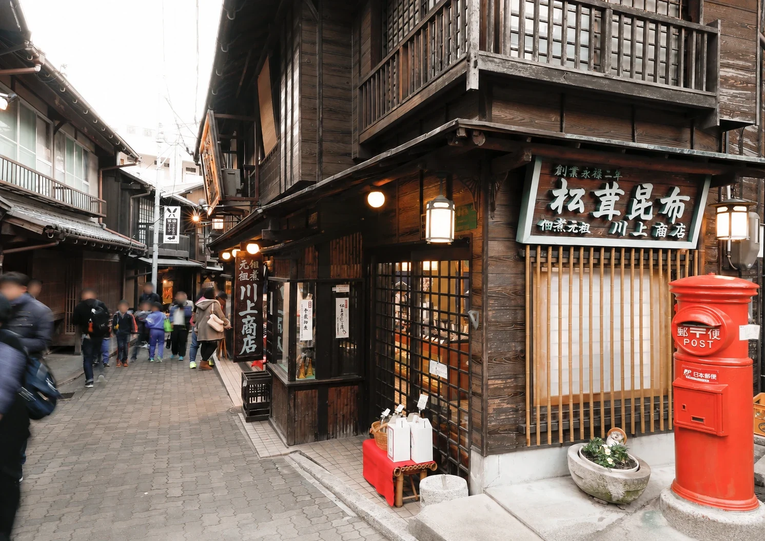 Historic wooden shops and a red post box in Arima Onsen