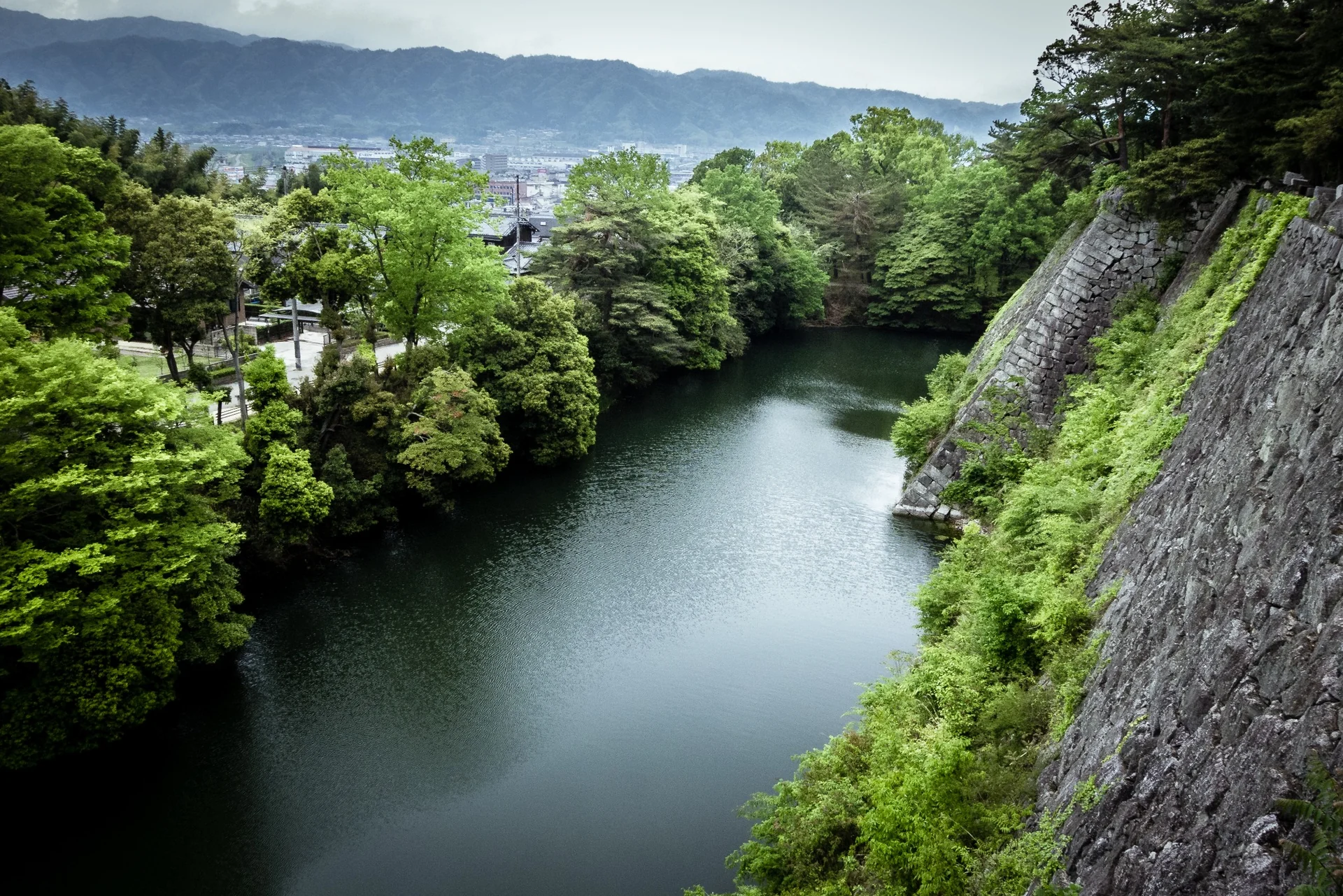 High stone walls and moat at Iga Ueno Castle