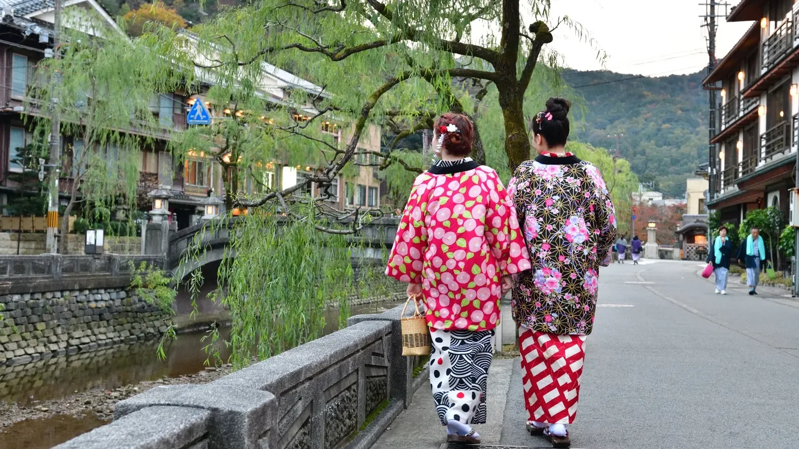 Travelers in yukata walking through Kinosaki Onsen in Hyogo, Japan