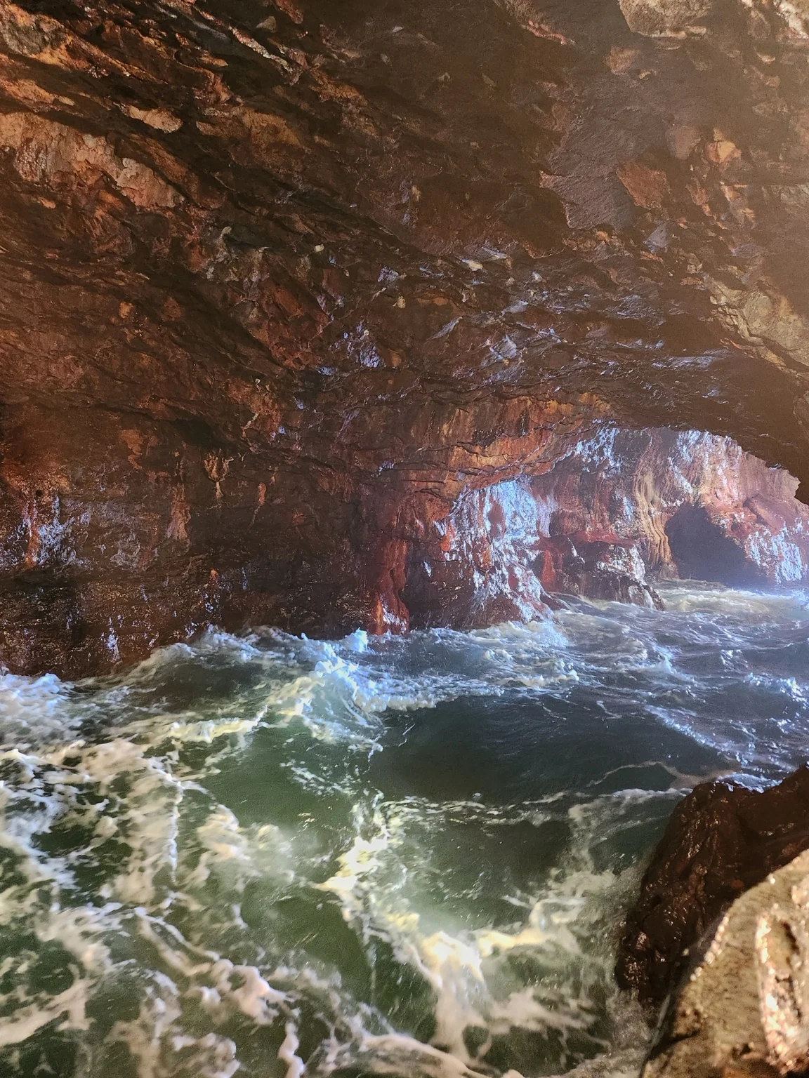 Waves crashing against the rocks inside Sandanbeki Cave in Shirahama