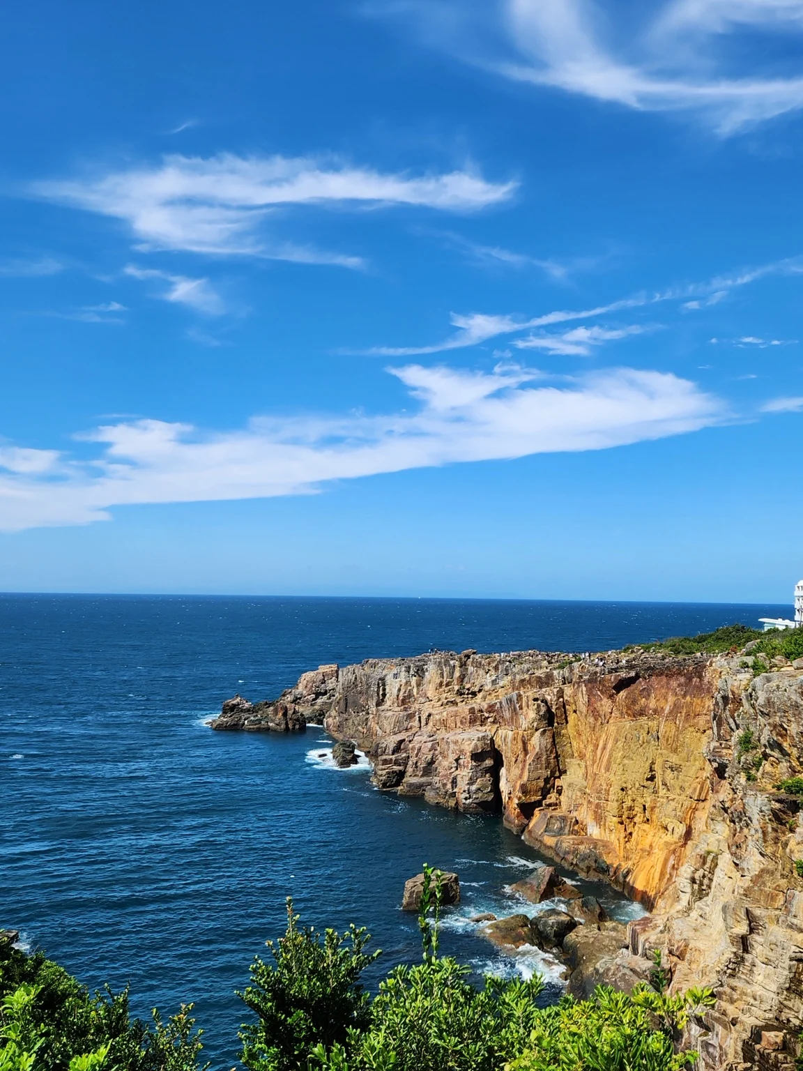 Rugged coastline and blue ocean at Sandanbeki in Shirahama